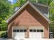 Attached two-car garage with white doors, offering convenience and ample parking at 12200 Glenlivet Way, Raleigh, NC 27613