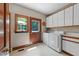 Functional laundry area with washer, dryer, storage cabinets, and natural light at 12200 Glenlivet Way, Raleigh, NC 27613
