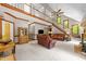 Open-concept living room with a staircase, vaulted ceilings, and comfortable leather seating at 12200 Glenlivet Way, Raleigh, NC 27613