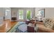 Inviting living room featuring hardwood floors, patterned rug, and comfortable seating at 12200 Glenlivet Way, Raleigh, NC 27613