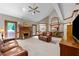 Spacious living room with vaulted ceilings, brick fireplace, and comfortable leather seating at 12200 Glenlivet Way, Raleigh, NC 27613
