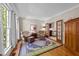 Cozy living room featuring hardwood floors, large windows, and elegant furnishings at 12200 Glenlivet Way, Raleigh, NC 27613
