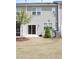 Townhome backyard featuring a screen porch, sliding glass door and young trees at 123 Hunston Dr, Holly Springs, NC 27540