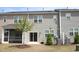 Townhome backyard featuring a screen porch, sliding glass door and young trees at 123 Hunston Dr, Holly Springs, NC 27540