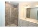 Bathroom featuring a glass enclosed shower, granite tile surround and double sink vanity at 123 Hunston Dr, Holly Springs, NC 27540