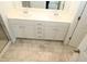 Bathroom with double sink vanity, tile floor and tile shower at 123 Hunston Dr, Holly Springs, NC 27540