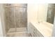 Bathroom featuring a glass enclosed shower, granite tile surround and double sink vanity at 123 Hunston Dr, Holly Springs, NC 27540