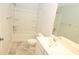 Bright bathroom featuring a modern vanity and bathtub with chrome fixtures at 123 Hunston Dr, Holly Springs, NC 27540