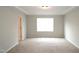 Spacious bedroom with ample natural light and neutral carpeting at 123 Hunston Dr, Holly Springs, NC 27540