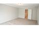 Cozy bedroom with neutral carpeting and a door leading to another room at 123 Hunston Dr, Holly Springs, NC 27540