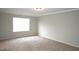 Bedroom features a window to let in natural light and neutral carpeting at 123 Hunston Dr, Holly Springs, NC 27540