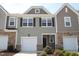 Charming townhome with a one-car garage, stone accents, and attractive curb appeal at 123 Hunston Dr, Holly Springs, NC 27540