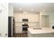 Bright kitchen featuring stainless steel appliances, white cabinets, and center island at 123 Hunston Dr, Holly Springs, NC 27540