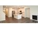 Open concept living area with kitchen, fireplace, hardwood floors, and natural light at 123 Hunston Dr, Holly Springs, NC 27540