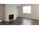 Inviting living room with a cozy fireplace and large window, perfect for relaxing at 123 Hunston Dr, Holly Springs, NC 27540