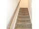 Carpeted staircase with wood railing for easy access to upper levels at 123 Hunston Dr, Holly Springs, NC 27540