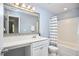 Bathroom boasts a vanity, toilet and shower/tub combo with striped curtain at 1238 Exchange Pl, Durham, NC 27713
