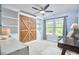Bedroom features a large Murphy bed with built in bookshelves and a ceiling fan at 1238 Exchange Pl, Durham, NC 27713