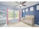 This bedroom features pink curtains, navy accent wall and a ceiling fan at 1238 Exchange Pl, Durham, NC 27713