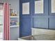 room displays a navy accent wall and decorative book shelf at 1238 Exchange Pl, Durham, NC 27713