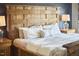 A traditionally decorated bedroom features a rustic wood bed frame, plush pillows, and wood nightstands with glass lamps at 1238 Exchange Pl, Durham, NC 27713