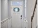 Entryway with door with glass panel, wainscoting and adjacent staircase at 1238 Exchange Pl, Durham, NC 27713