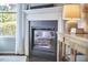 Cozy fireplace with white mantel and glass front, complemented by a stylish lamp at 1238 Exchange Pl, Durham, NC 27713