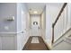 Welcoming hallway with hardwood floors, white trim, and a staircase leading to the upper level at 1238 Exchange Pl, Durham, NC 27713