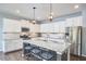Modern kitchen featuring stainless steel appliances, granite countertops, and ample cabinet space at 1238 Exchange Pl, Durham, NC 27713