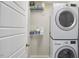 Laundry Room features stacked washer and dryer with shelving for storage at 1238 Exchange Pl, Durham, NC 27713