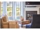 Beautiful living room with a fireplace, large windows, and hardwood floors at 1238 Exchange Pl, Durham, NC 27713
