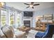 The living room has a fireplace, large windows, hardwood floors, and a decorative console table at 1238 Exchange Pl, Durham, NC 27713