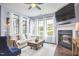 Bright living room features a fireplace, large windows, and hardwood floors at 1238 Exchange Pl, Durham, NC 27713
