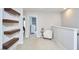 This loft area features floating shelves, a comfortable chair, and access to other rooms at 1238 Exchange Pl, Durham, NC 27713