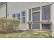 Exterior view of screened in porch with string lights, flower boxes and green space at 1238 Exchange Pl, Durham, NC 27713