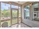 Screened in porch with string lights, outdoor seating, and landscaped yard at 1238 Exchange Pl, Durham, NC 27713
