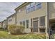 Tan-sided home with a screened-in porch with flower boxes and view of the tidy, fenced back yard at 1238 Exchange Pl, Durham, NC 27713