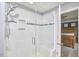 This shower features white tile with black accents, a built-in niche, and a glass door at 1238 Exchange Pl, Durham, NC 27713