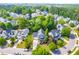Aerial view of a neighborhood showcases the home's location with mature trees and beautiful surroundings at 1241 Dalgarven Dr, Apex, NC 27502