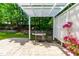 Great backyard patio with built in grill, flowering plants and string lights for ambiance at 1241 Dalgarven Dr, Apex, NC 27502