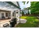 Backyard featuring a pergola, grill, and lush green lawn for relaxing and outdoor entertainment at 1241 Dalgarven Dr, Apex, NC 27502
