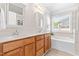 Bright bathroom with a soaking tub, tile backsplash and double vanity at 1241 Dalgarven Dr, Apex, NC 27502