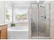 Bathroom featuring a shower, soaking tub and large window at 1241 Dalgarven Dr, Apex, NC 27502