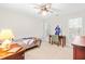 Neutral bedroom with a sports motif, complete with a ceiling fan, desk, and baseball-themed bedding at 1241 Dalgarven Dr, Apex, NC 27502