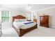Spacious bedroom with a large bed, soft carpet and adjoining bathroom at 1241 Dalgarven Dr, Apex, NC 27502