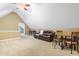 Spacious bonus room with a vaulted ceiling, a ceiling fan, carpeting and seating and table at 1241 Dalgarven Dr, Apex, NC 27502