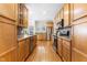 Spacious kitchen featuring wood cabinets, stainless steel appliances, and a center island with a sink at 1241 Dalgarven Dr, Apex, NC 27502