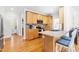 Bright kitchen featuring wood cabinets, countertop seating, and an open layout to the rest of the home at 1241 Dalgarven Dr, Apex, NC 27502