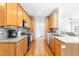 Well-lit kitchen boasts wood cabinets, modern appliances, and an open layout to other areas of the home at 1241 Dalgarven Dr, Apex, NC 27502