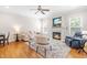Cozy living room featuring a fireplace, hardwood floors, and comfortable seating at 1241 Dalgarven Dr, Apex, NC 27502
